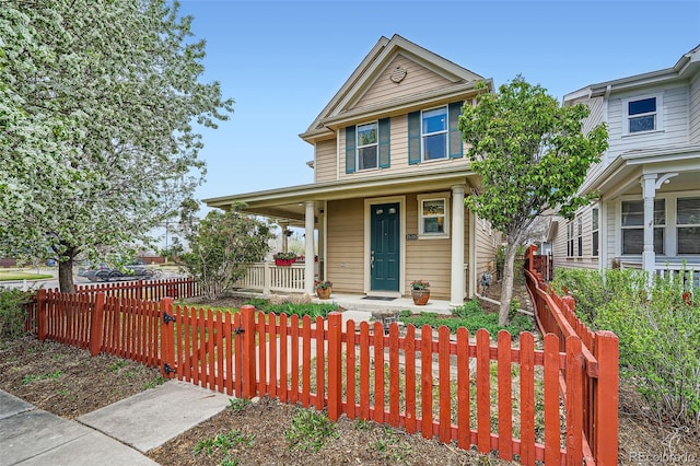 2538 Central Park Blvd, Denver, CO 80238 - view of front of house featuring a porch and a fenced front yard