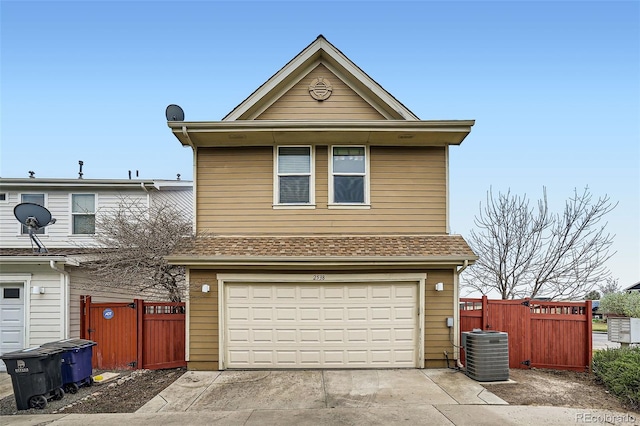 2538 Central Park Blvd, Denver, CO 80238 - traditional-style home with an attached garage, concrete driveway, and a gate