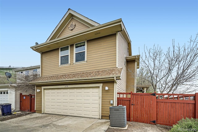 2538 Central Park Blvd, Denver, CO 80238 - view of front facade featuring an attached garage, concrete driveway, and a gate