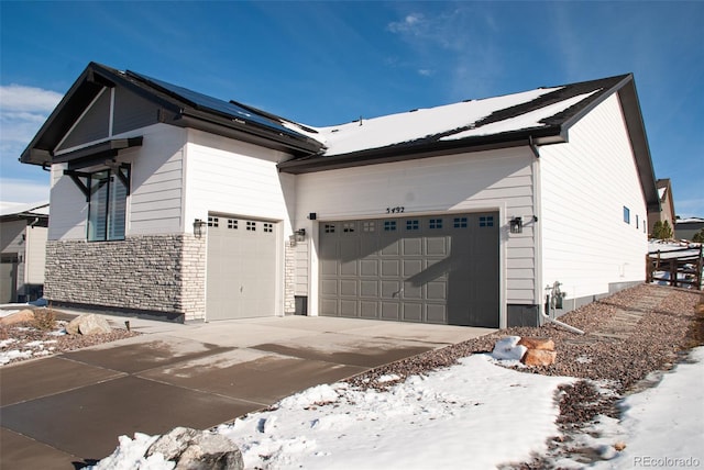 view of snow covered exterior with a garage