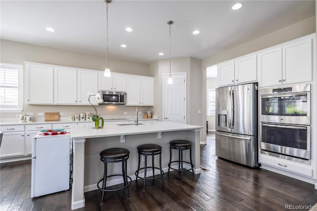 26722 E Peakview Pl, Aurora, CO 80016 - kitchen featuring stainless steel appliances, dark wood finished floors, white cabinetry, and recessed lighting