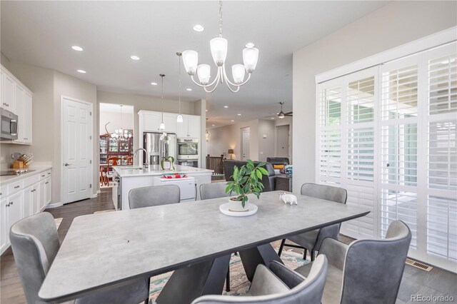 26722 E Peakview Pl, Aurora, CO 80016 - dining space featuring a chandelier, ceiling fan, recessed lighting, and dark wood finished floors