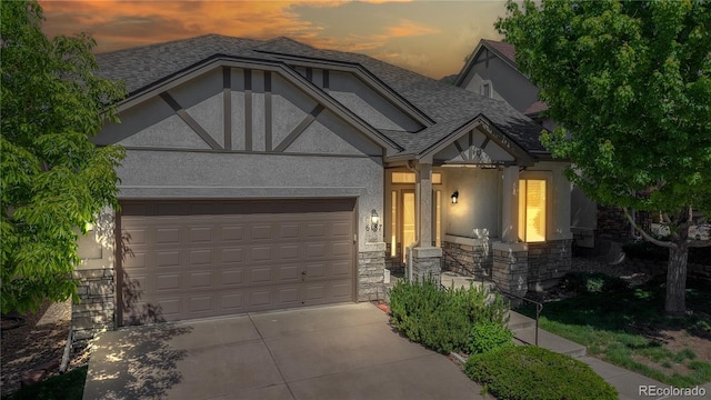 6187 Reed Way, Arvada, CO 80003 - view of front of home with stucco siding, stone siding, concrete driveway, a garage, and a shingled roof