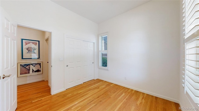 6187 Reed Way, Arvada, CO 80003 - unfurnished bedroom with light wood-style floors and a closet