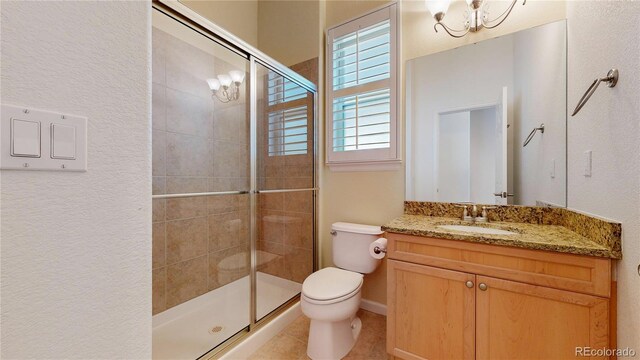 6187 Reed Way, Arvada, CO 80003 - full bath featuring a shower stall, vanity, and a textured wall