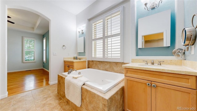 6187 Reed Way, Arvada, CO 80003 - full bathroom with two vanities, a whirlpool tub, tile patterned floors, and ceiling fan