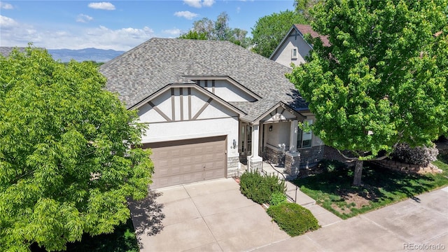 6187 Reed Way, Arvada, CO 80003 - english style home featuring stucco siding, driveway, an attached garage, roof with shingles, and stone siding