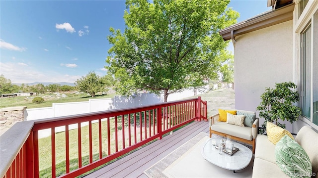 6187 Reed Way, Arvada, CO 80003 - wooden deck featuring a fenced backyard, an outdoor hangout area, and a mountain view