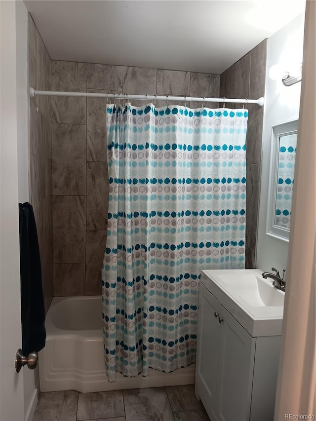 bathroom featuring vanity, tile patterned floors, and shower / bath combo with shower curtain