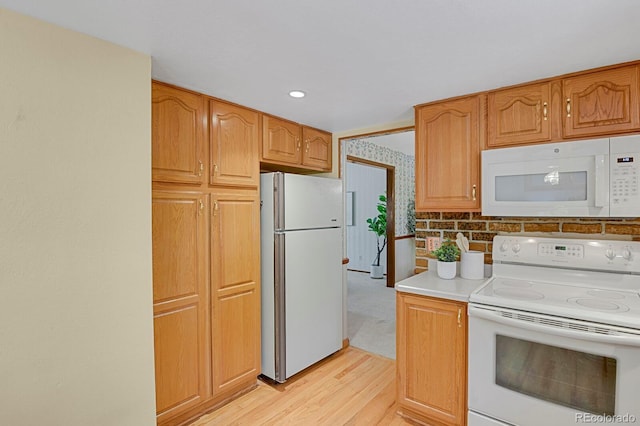 8277 Teller Ct, Arvada, CO 80003 - kitchen featuring white appliances, light wood-style flooring, and light countertops