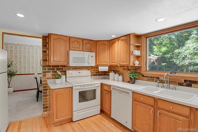 8277 Teller Ct, Arvada, CO 80003 - kitchen featuring white appliances, light countertops, light wood-style floors, open shelves, and wallpapered walls