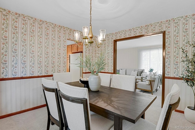 8277 Teller Ct, Arvada, CO 80003 - dining area featuring wallpapered walls, a chandelier, and light carpet