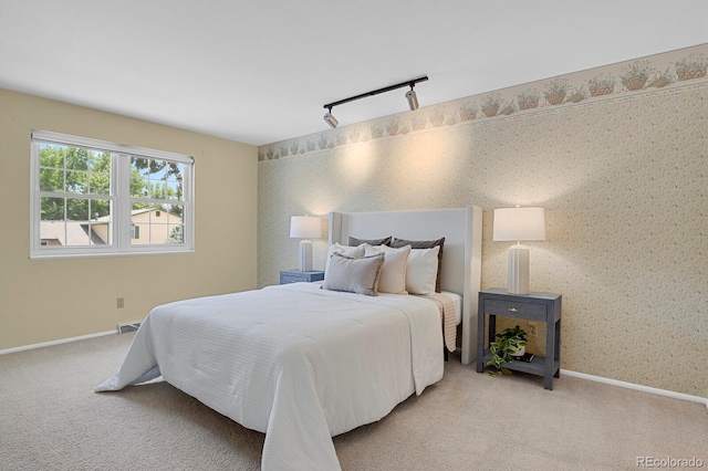 8277 Teller Ct, Arvada, CO 80003 - bedroom featuring rail lighting, light colored carpet, and wallpapered walls
