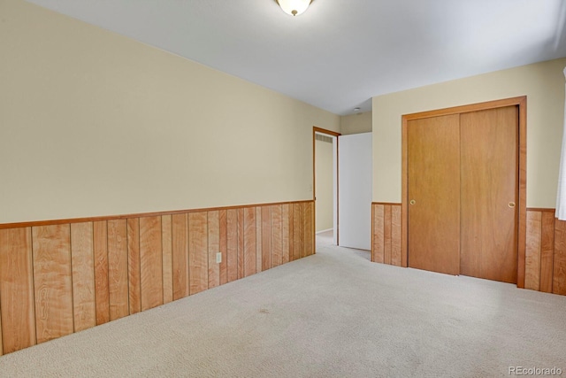 8277 Teller Ct, Arvada, CO 80003 - unfurnished bedroom with carpet flooring, wainscoting, wooden walls, and a closet