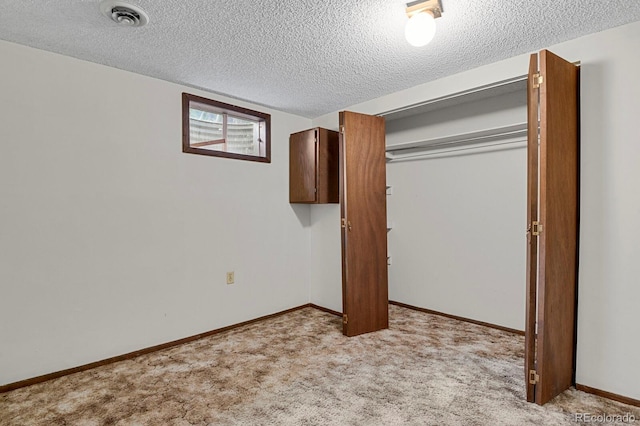 8277 Teller Ct, Arvada, CO 80003 - unfurnished bedroom featuring a textured ceiling, light carpet, and a closet
