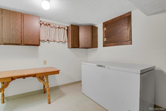 8277 Teller Ct, Arvada, CO 80003 - laundry area featuring a textured ceiling and light floors