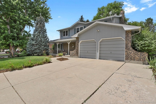 8277 Teller Ct, Arvada, CO 80003 - view of front of house featuring brick siding, a garage, a front lawn, a chimney, and driveway