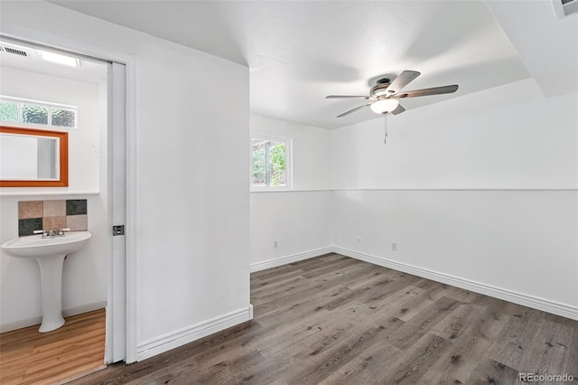 9315 Field Ln, Westminster, CO 80021 - spare room featuring wood finished floors, ceiling fan, baseboards, and a sink