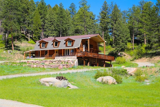 60 N County Highway 67, Sedalia, CO 80135 - view of front of house with log exterior and an outdoor fire pit
