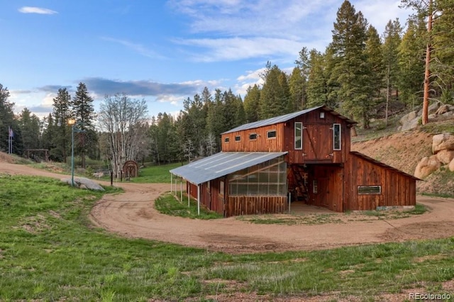 60 N County Highway 67, Sedalia, CO 80135 - view of outbuilding with dirt driveway and a wooded view