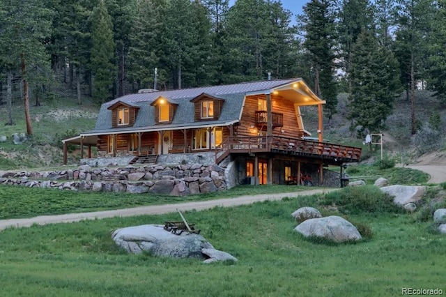 60 N County Highway 67, Sedalia, CO 80135 - log-style house with a view of trees, log siding, a metal roof, a front yard, and a standing seam roof