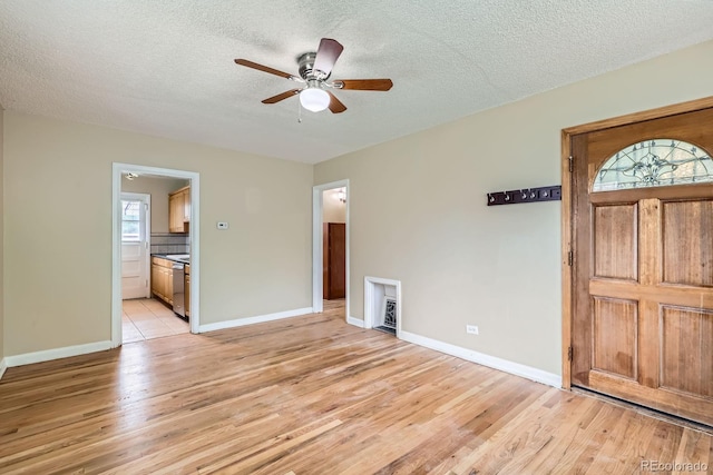 1325 Geneva St, Aurora, CO 80010 - foyer entrance featuring light wood-style flooring, a ceiling fan, a textured ceiling, and baseboards