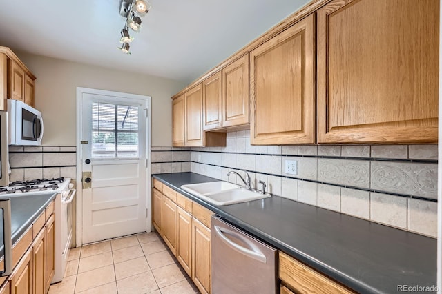 1325 Geneva St, Aurora, CO 80010 - kitchen featuring white appliances, a sink, light tile patterned flooring, decorative backsplash, and dark countertops