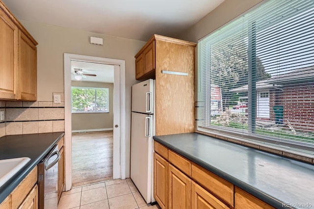 1325 Geneva St, Aurora, CO 80010 - kitchen featuring freestanding refrigerator, dark countertops, dishwasher, tasteful backsplash, and ceiling fan