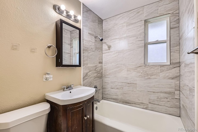 1325 Geneva St, Aurora, CO 80010 - full bathroom featuring vanity, toilet, tub / shower combination, and a textured wall
