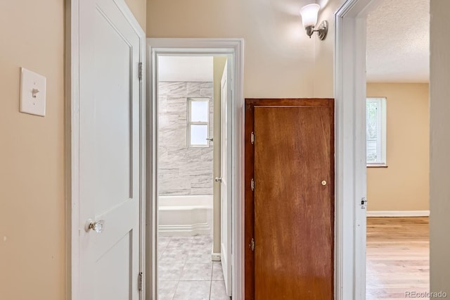 1325 Geneva St, Aurora, CO 80010 - hallway featuring healthy amount of natural light and a textured ceiling