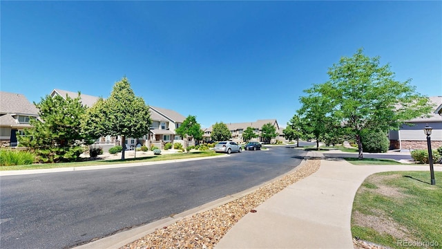 4718 Raven Run, Broomfield, CO 80023 - view of asphalt road with a residential view, sidewalks, and curbs