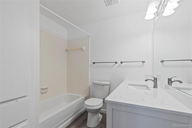 full bathroom with visible vents, toilet, a textured ceiling, wood finished floors, and vanity