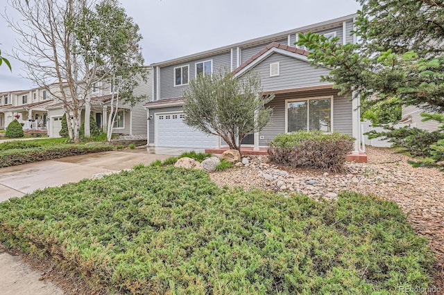 5120 Perth St, Denver, CO 80249 - view of front of home featuring an attached garage and driveway