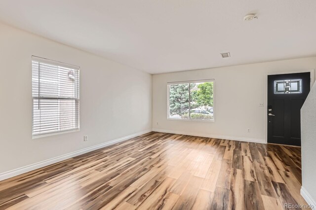 5120 Perth St, Denver, CO 80249 - spare room featuring wood finished floors and baseboards