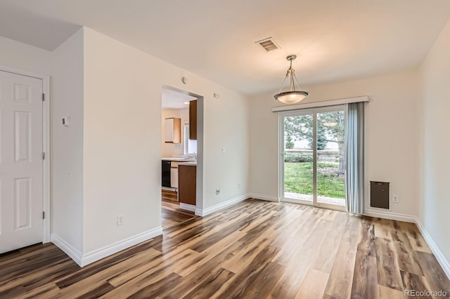5120 Perth St, Denver, CO 80249 - unfurnished dining area with wood finished floors, baseboards, and a sink