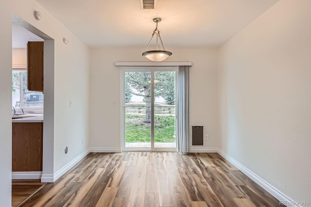 5120 Perth St, Denver, CO 80249 - unfurnished dining area featuring wood finished floors and baseboards