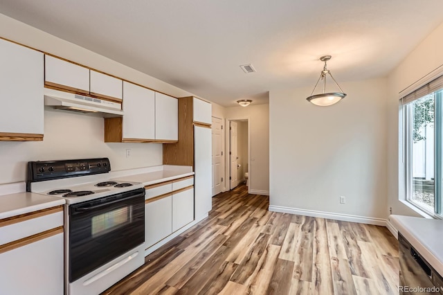 5120 Perth St, Denver, CO 80249 - kitchen featuring electric stove, under cabinet range hood, white cabinets, light countertops, and light wood-type flooring