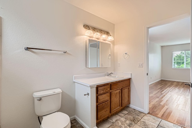 5120 Perth St, Denver, CO 80249 - bathroom with vanity, toilet, tile patterned floors, and baseboards
