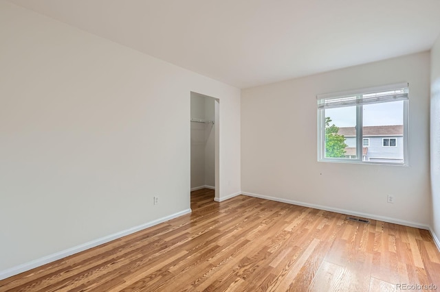 5120 Perth St, Denver, CO 80249 - unfurnished bedroom with light wood finished floors, baseboards, and a closet