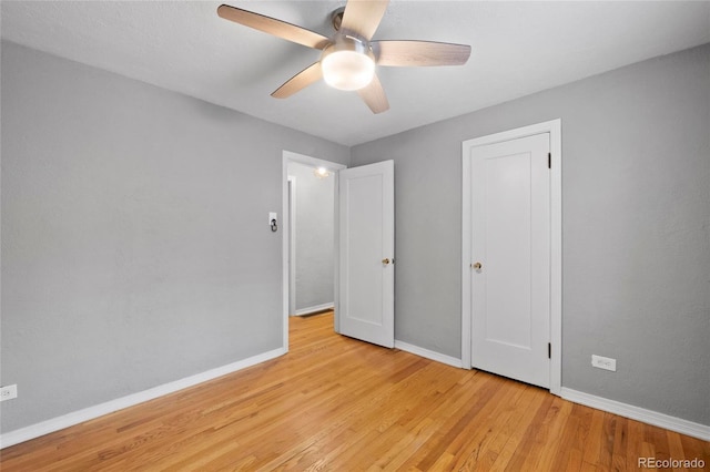 unfurnished bedroom with a ceiling fan, light wood-type flooring, and baseboards