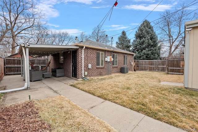 view of property exterior with brick siding, a fenced backyard, a patio, and a yard