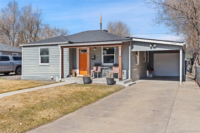 view of front of home featuring a porch, a front yard, concrete driveway, and a shingled roof