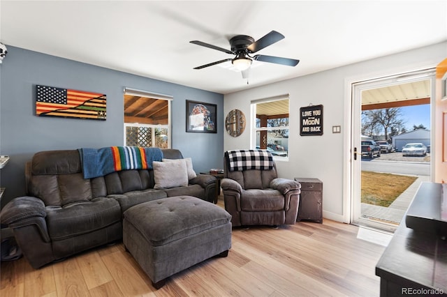 living area featuring a ceiling fan and light wood finished floors