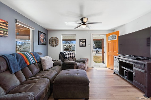 living room featuring light wood-type flooring, plenty of natural light, and ceiling fan