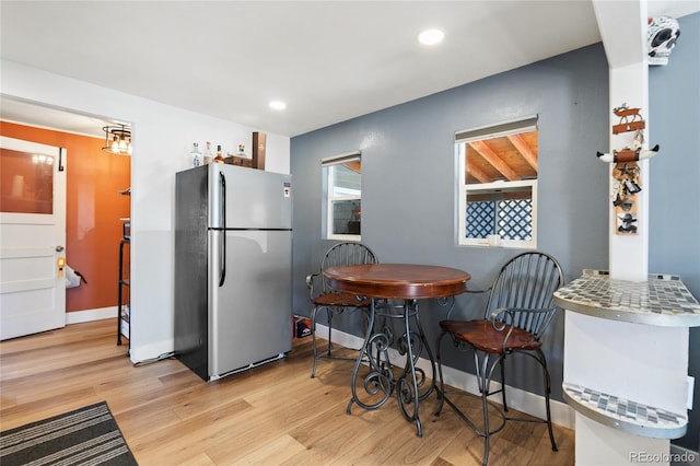 kitchen featuring light wood-style floors, recessed lighting, and freestanding refrigerator