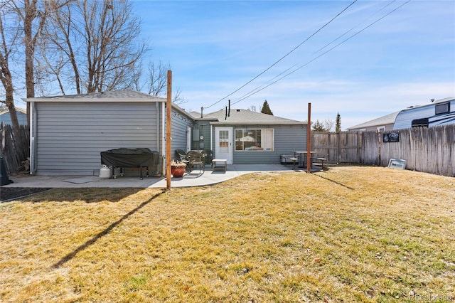 back of property with a patio area, fence, and a lawn