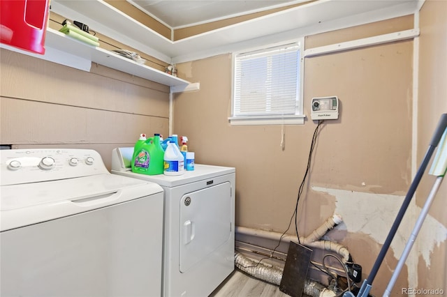 washroom with laundry area, light wood finished floors, and independent washer and dryer