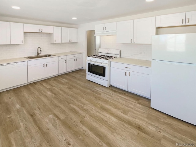 1298 S Seneca Way, Denver, CO 80223 - kitchen with white appliances, under cabinet range hood, white cabinets, backsplash, and recessed lighting