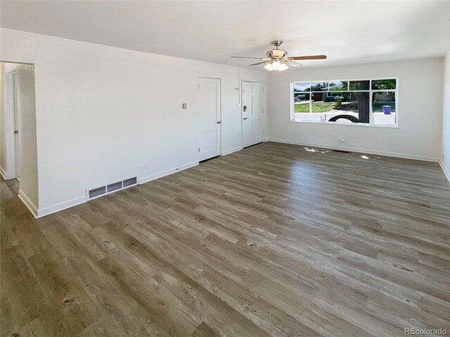 1298 S Seneca Way, Denver, CO 80223 - unfurnished living room featuring wood finished floors and a ceiling fan