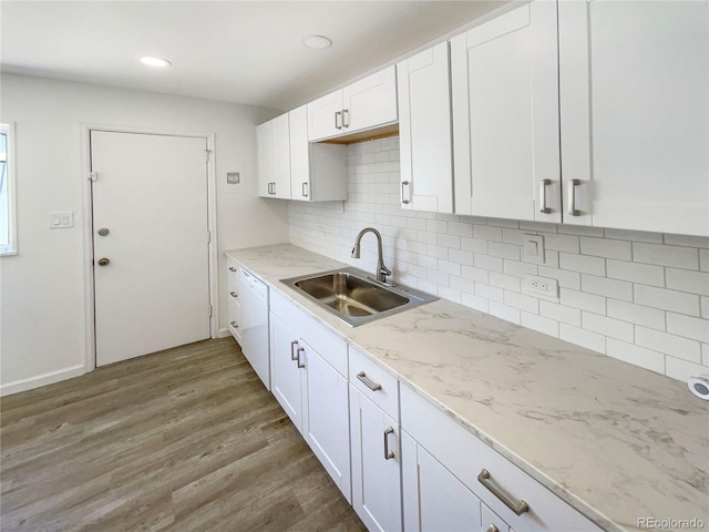 1298 S Seneca Way, Denver, CO 80223 - kitchen featuring white cabinetry, wood finished floors, decorative backsplash, light stone counters, and recessed lighting